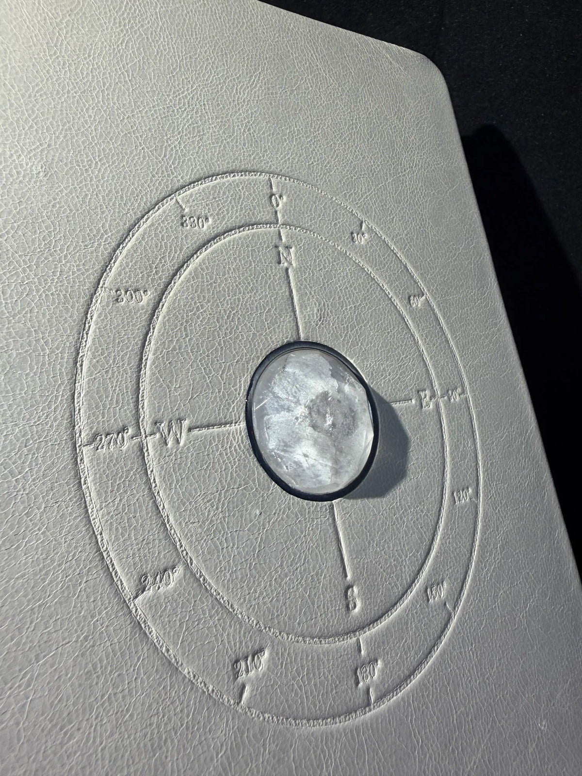 Full-grain leather, natural clear quartz inlay, and circular detailing on The Luminous Journal