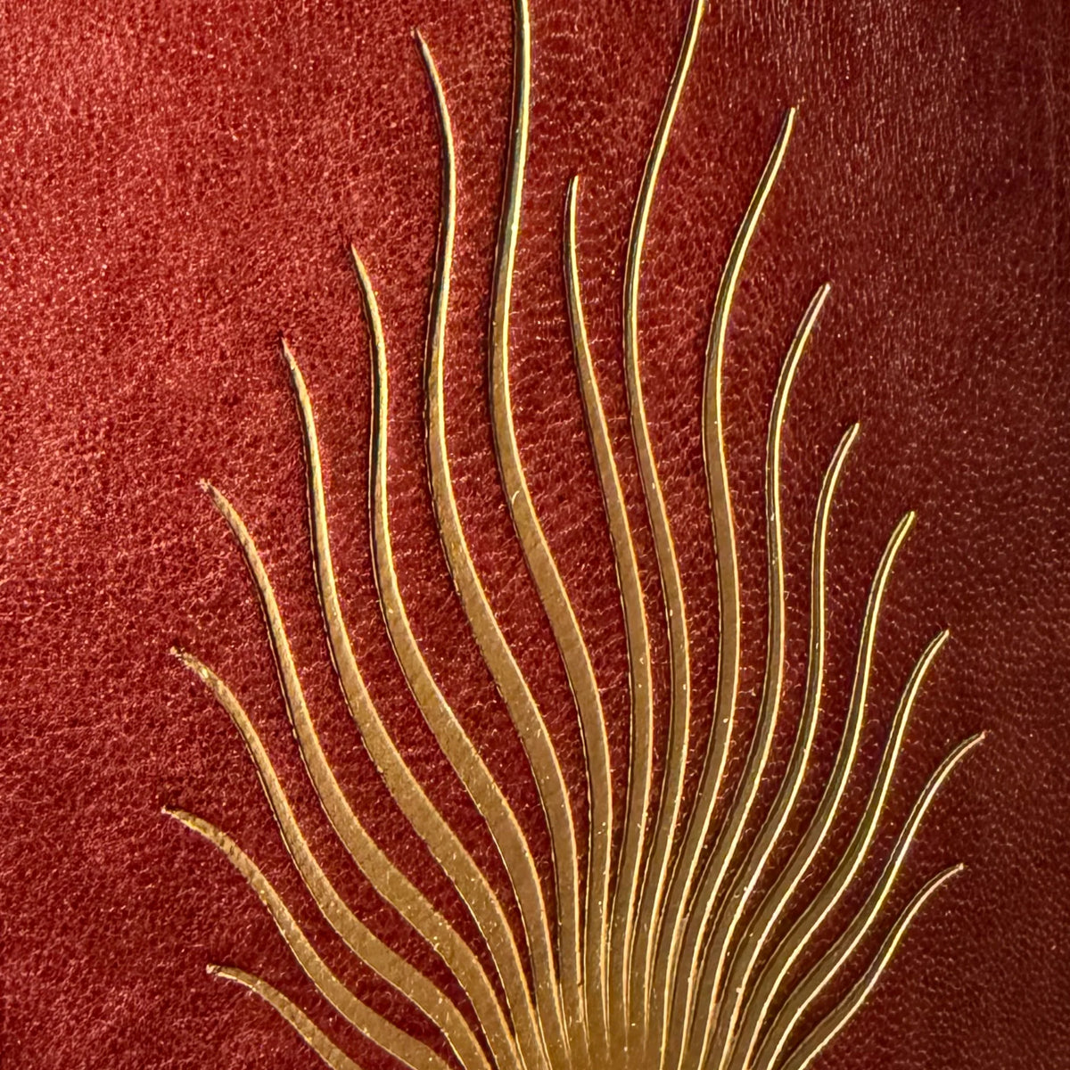 Full-grain leather, natural red jasper inlay, and hand-finished binding on The Ember Journal