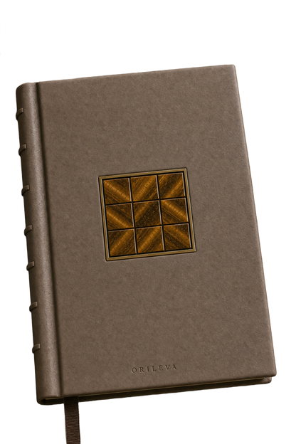 The Grounded Journal front cover — tiger's eye grid inlay in a gold frame, with exposed-spine binding