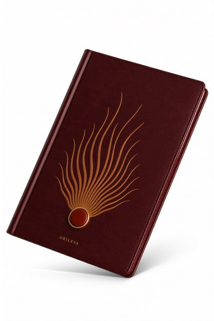 The Ember Journal balanced on its corner, Fire element cover in warm light