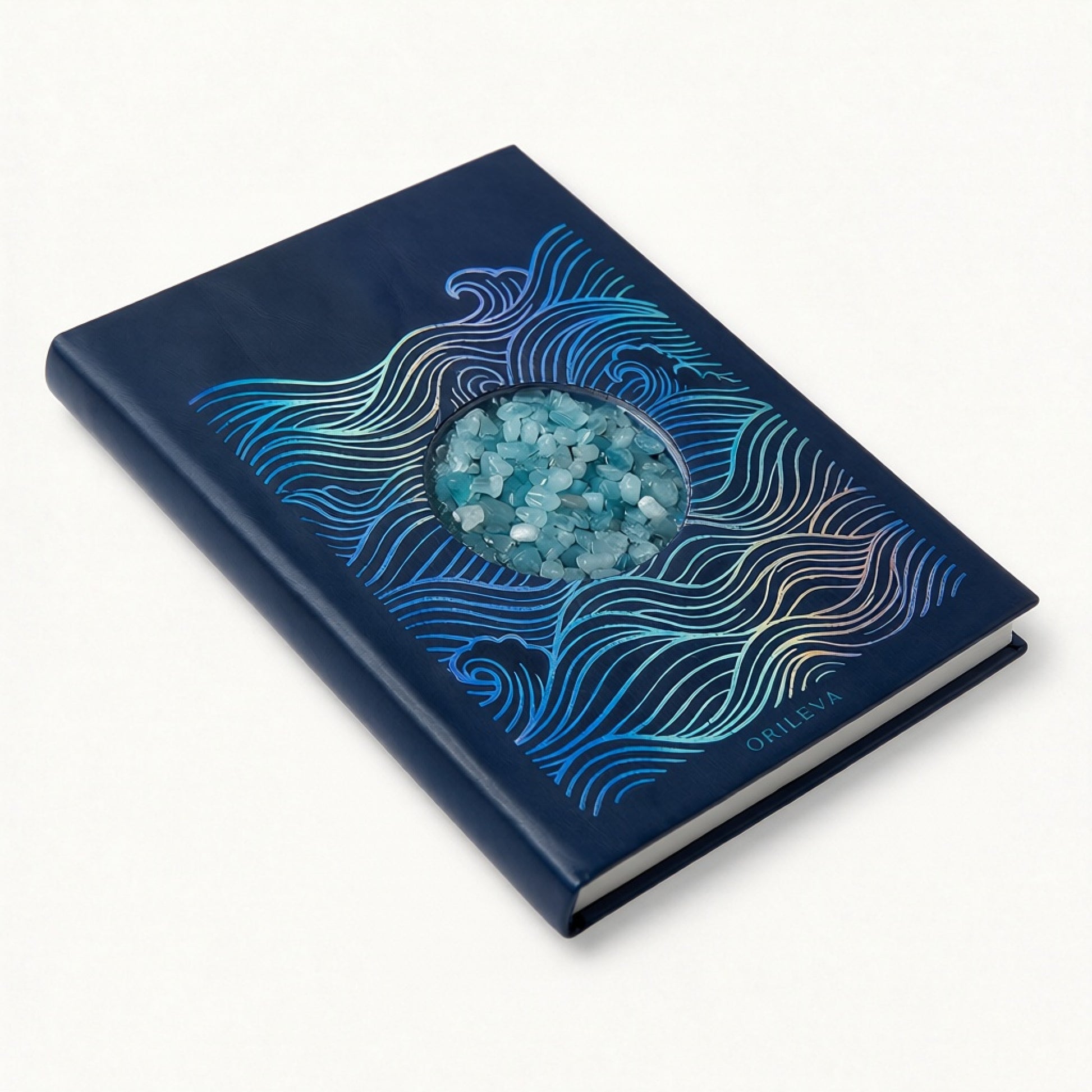 The Tidal Journal lying flat, Water element cover with aquamarine stones catching the light