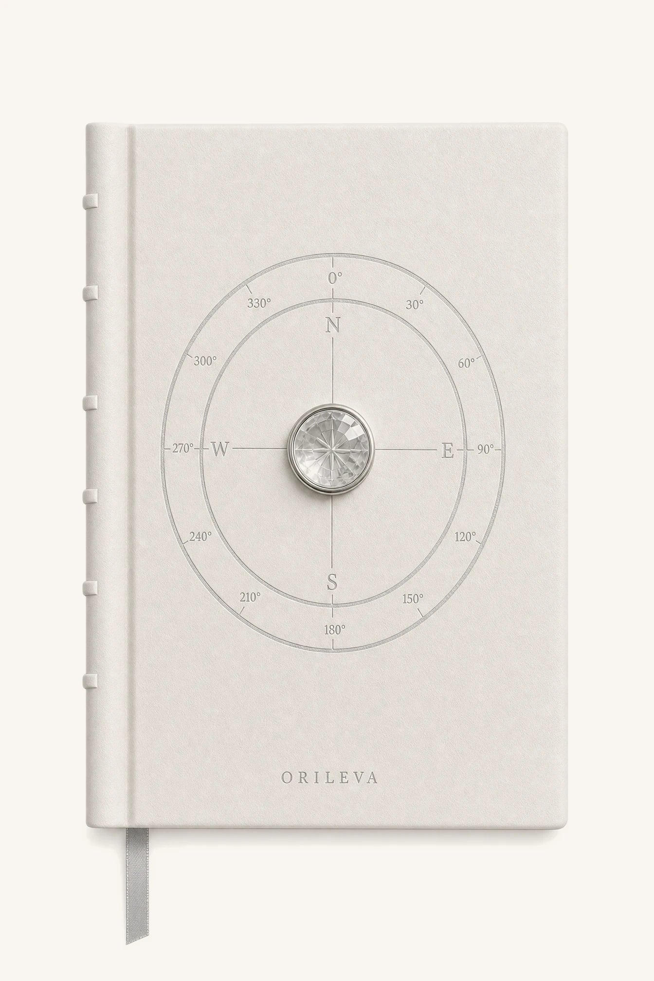 The Luminous Journal — pale leather cover with compass linework and natural clear quartz inlay