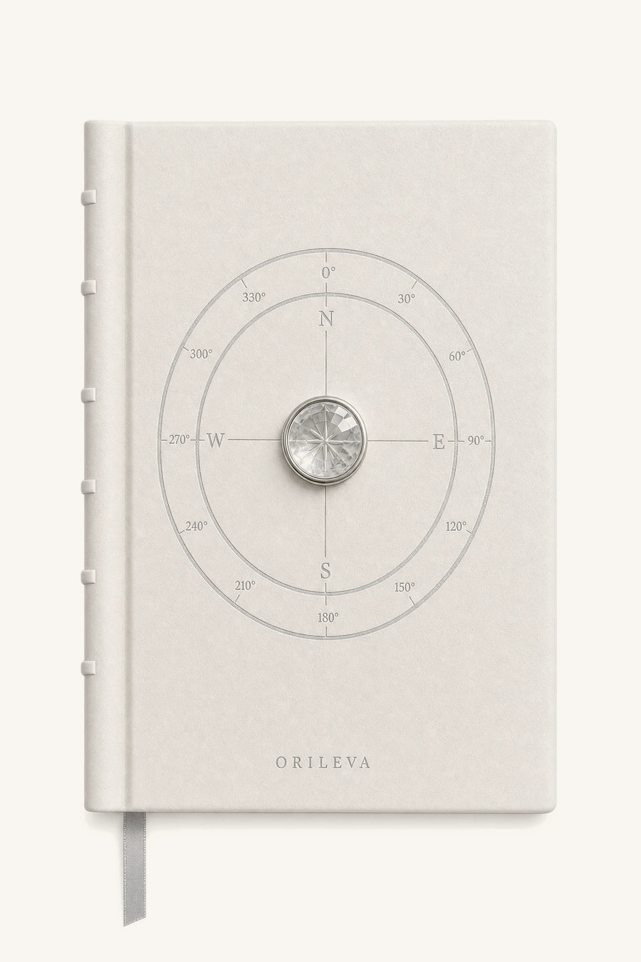 The Luminous Journal — pale leather cover with compass linework and natural clear quartz inlay