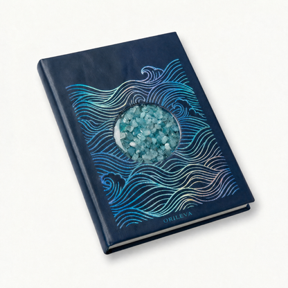 The Tidal Journal at an angle, showing iridescent waves, aquamarine inlay, and ivory page edges