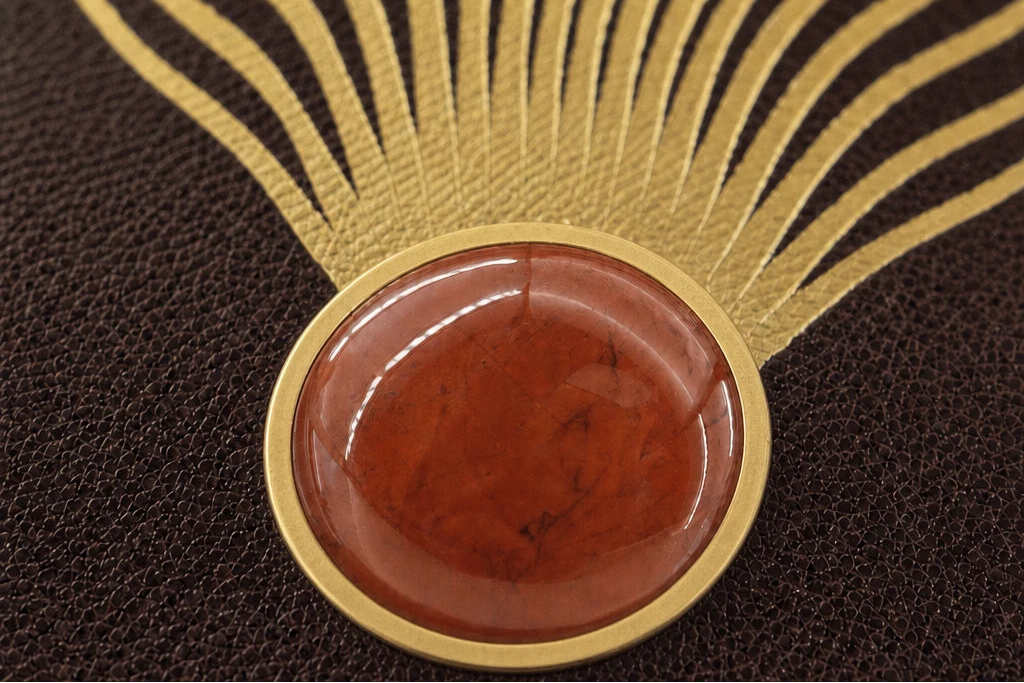 Natural red jasper set by hand into The Ember Journal